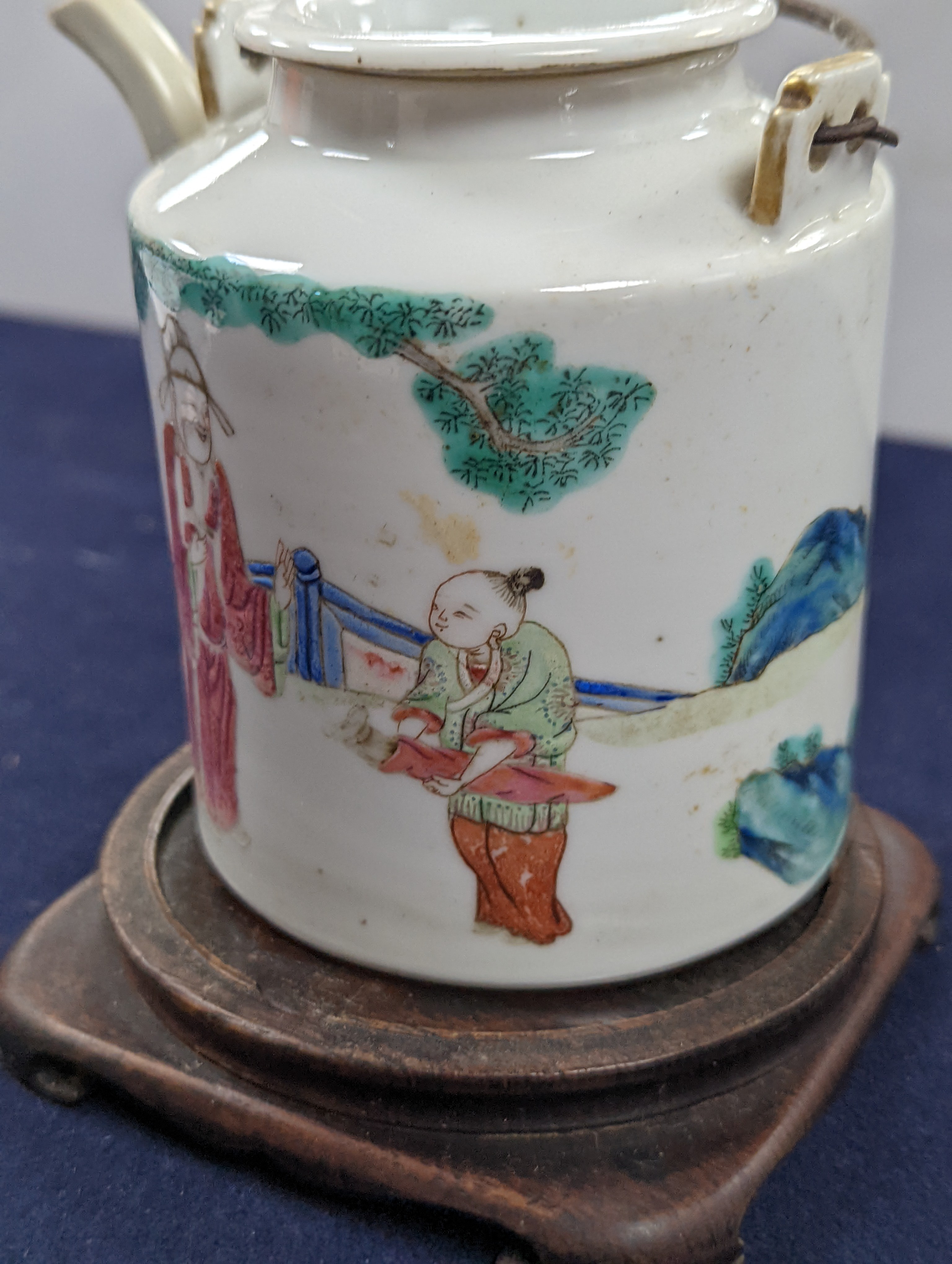 A Chinese famille rose cylindrical teapot and cover, 19th century 11cm, wood stand